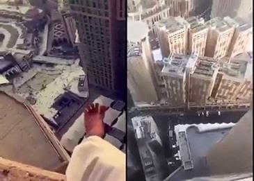 شاهد شاب يقف على حافة برج الساعة